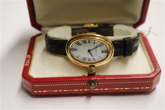 A ladys 18ct gold Cartier oval cased wrist watch, with Cartier box.